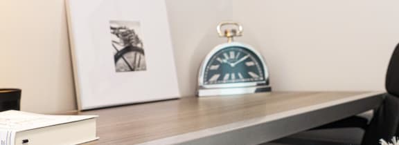 a desk with a lamp and a chair in a room