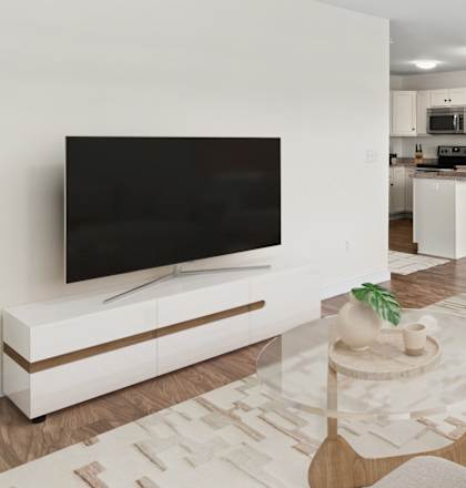 A modern living room with a large television and comfortable seating.