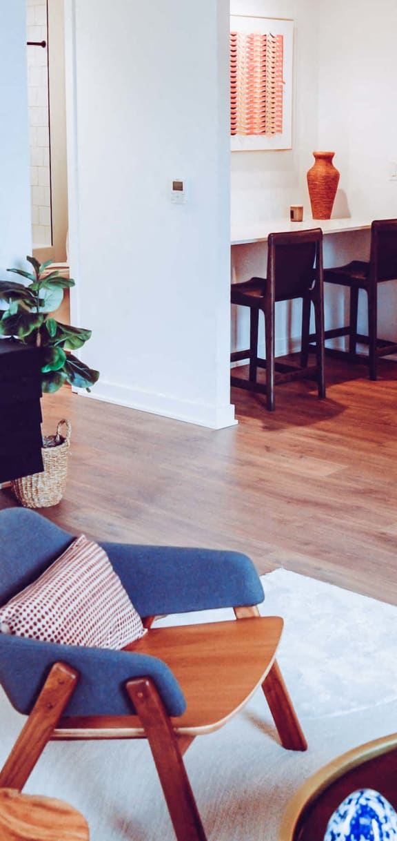 a kitchen with an island and stools in a living room