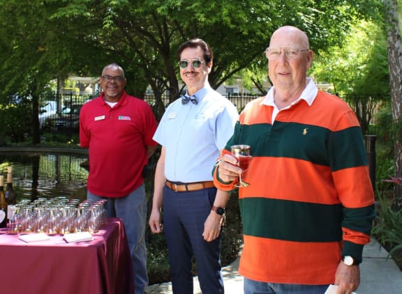 a large group of people sitting at tables applauding at Campus Commons Senior Living, Sacramento, CA 95825