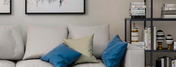 A modern living room with a white sofa, a coffee table, and two abstract paintings on the wall at Alys Crossing Apartments Apartments, Cypress, TX 77433