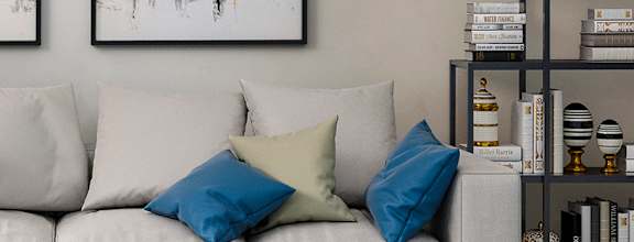 A modern living room with a white sofa, a coffee table, and a TV at Capital Creek at Heritage Apartments, NC, 27587