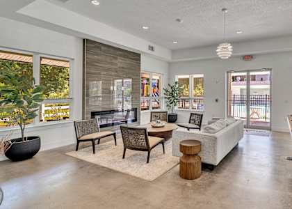 A spacious living room with a pool table and comfortable seating.