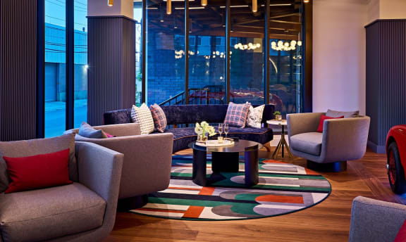 a living room with couches and chairs and a rug at Dey & Bergen, Harrison, 07029