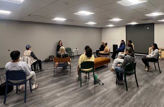 A group of people are sitting in a circle in a room. at Walnut View Apartments, Pennsylvania, 18102
