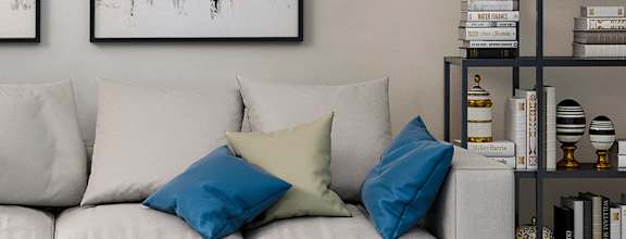 A modern living room with a white sofa, a coffee table, and two abstract paintings on the wall at The Addison, Baton Rouge, LA 70836