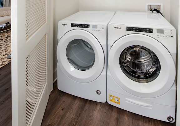 A small laundry room with two front loading washing machines at The Cottages at Old Monrovia Apartment , Alabama, 35806