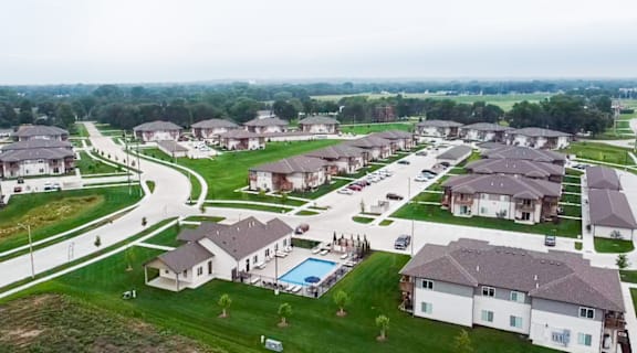 an aerial view of a neighborhood of houses with a swimming pool