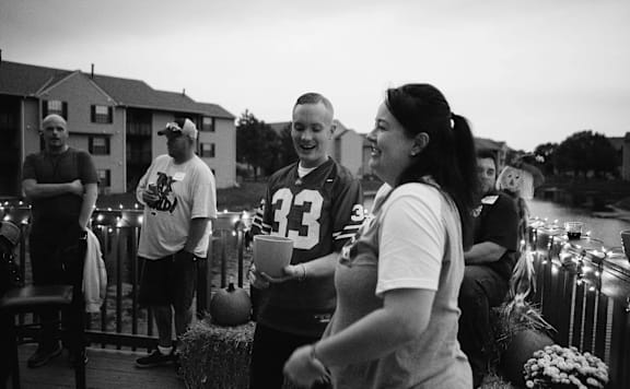 A woman in a white shirt with the number 33 on it is standing next to a man in a white shirt with the number 33 on it.