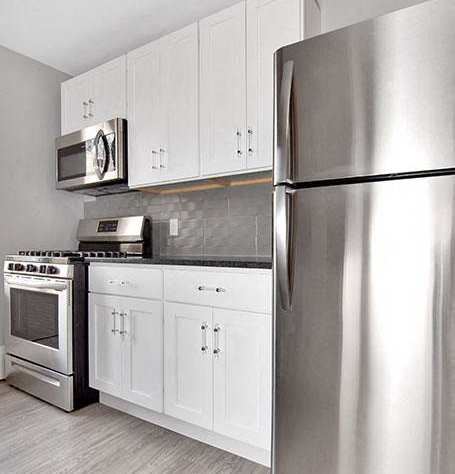 A modern kitchen with a stainless steel refrigerator.