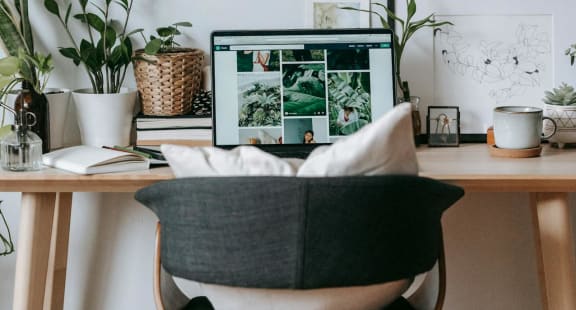 A home office with a desk, chair, and computer.