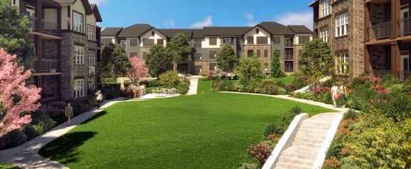 a rendering of an apartment complex with a green lawn