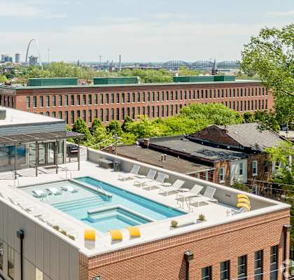 A rooftop pool is surrounded by apartment buildings. at 1400 Russell Apartments, Saint Louis, MO, 63104