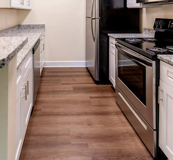 a kitchen with stainless steel appliances and white cabinets