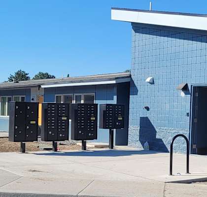 A blue building with a yellow triangle on the side.