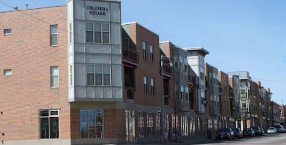 A row of buildings with the first one reading Columbia Square.