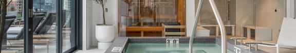 a large jacuzzi pool in the middle of a room with glass doors at Cassidy on Canal, Chicago, Illinois, 60654