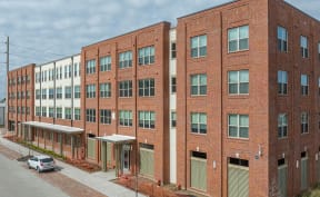 a large brick building with a street in front of it