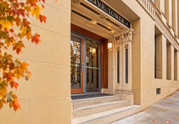 The entrance to a building with a glass door and a sign above it.