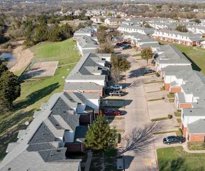 an aerial view of a row of houses in a neighborhood