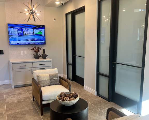 A modern living room with a flat screen TV mounted on the wall at Stella, San Tan Valley, AZ 85143