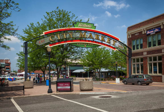 a view of a street with a red arch and a green sign on top of it