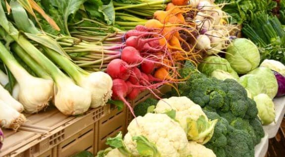 a table topped with lots of different types of vegetables