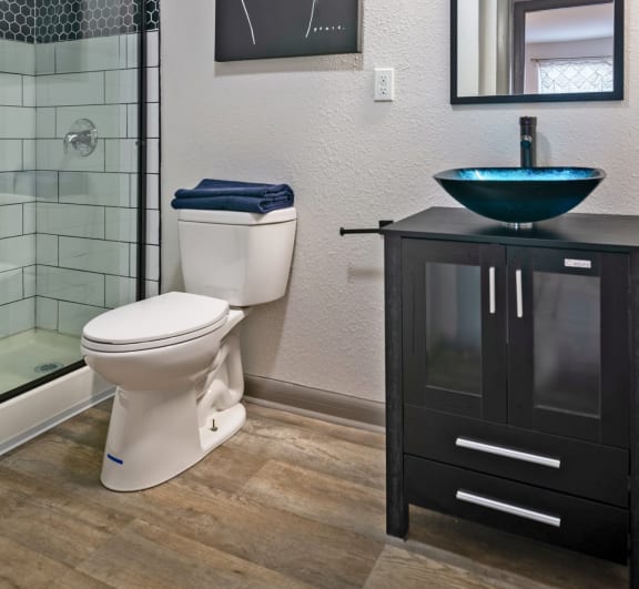 Bathroom in The Canvas 2 bedroom apartment in Nashville, TN with large custom tile shower and basin sink