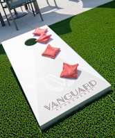 grassy area with cornhole boards