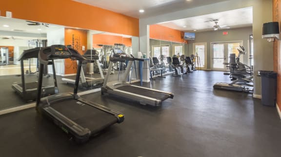 a gym with cardio equipment and a ceiling fan at Valencia Park, Phoenix, AZ