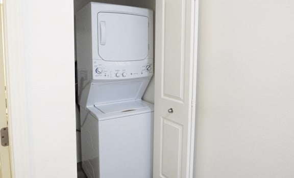 A white dishwasher and microwave are in a small kitchen.