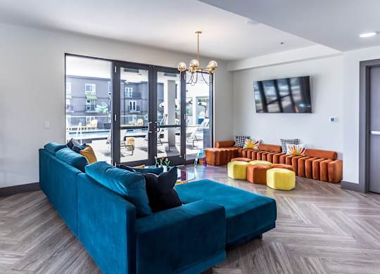 a living room with a blue couch and a tv
