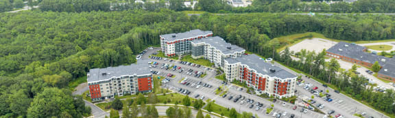 an aerial view of a large apartment complex in a wooded area