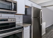 Thumbnail 3 of 22 - a kitchen with stainless steel appliances and white cabinets