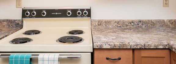 a kitchen with wooden cabinets and white appliances and granite counter tops