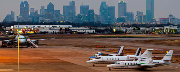 a view of the dallas fort worth international airport with several planes parked on the tarmac