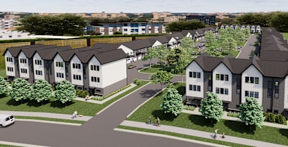 A row of houses with a park in front.