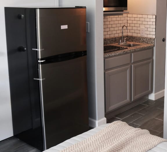 a small kitchen with a refrigerator and a sink at Schaefer Ridge Apartments, Missouri, 65616