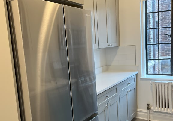 a kitchen with a fridge and a window