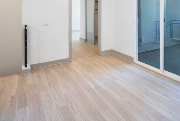 a renovated living room and hallway with sliding glass doors to a balcony