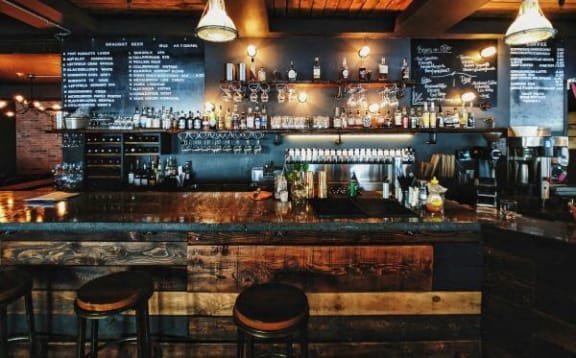 a bar with bar stools in a bar