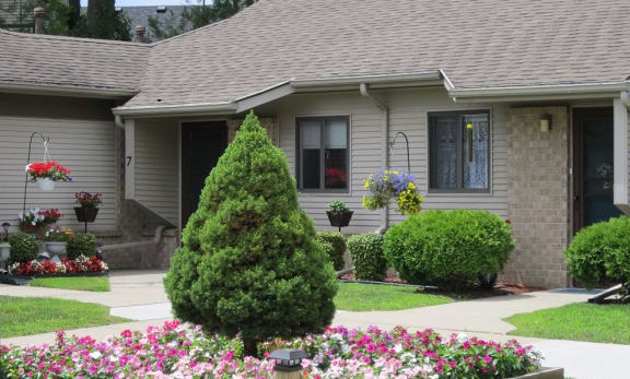 a house with a flower garden in front of it
