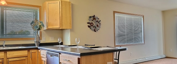 an empty kitchen with wooden cabinets and a counter top