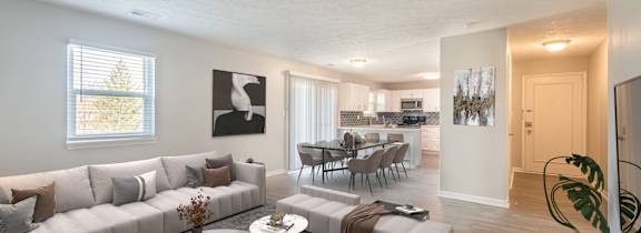 A living room with a grey sofa and a coffee table.
