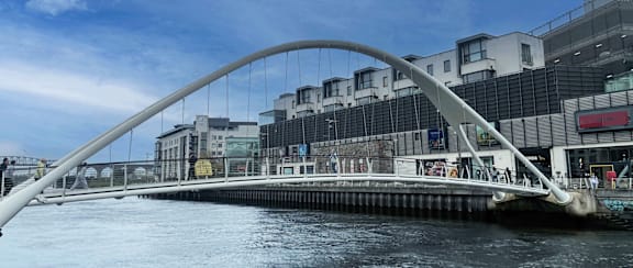 a bridge over the water in front of a building