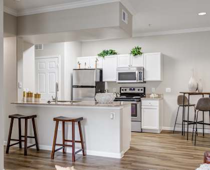 an open kitchen and living room with a couch and a table