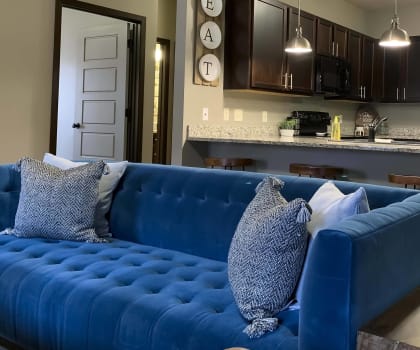 Furnished living room with blue sofa at north pointe villas in lincoln ne
