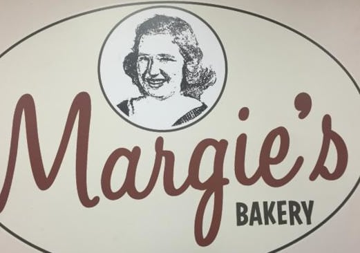 a bakery sign with a picture of a man on it