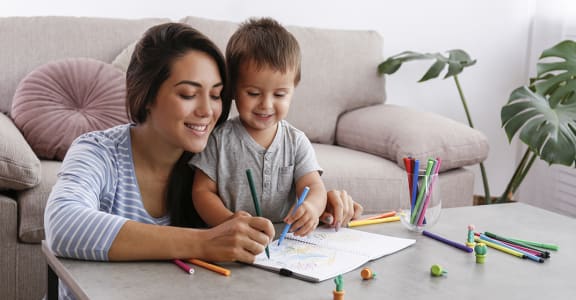 Mom and child coloring at home