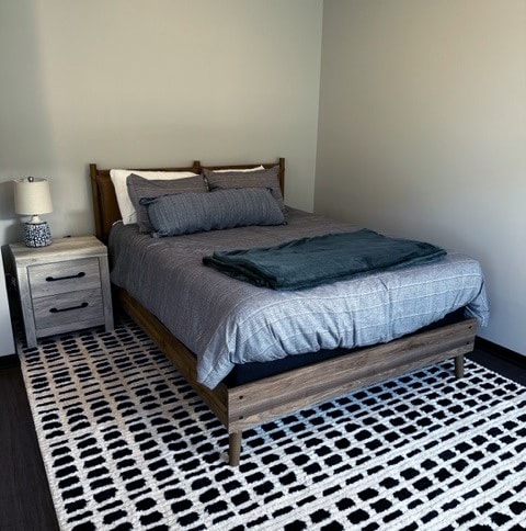 a bedroom with a bed and two nightstands